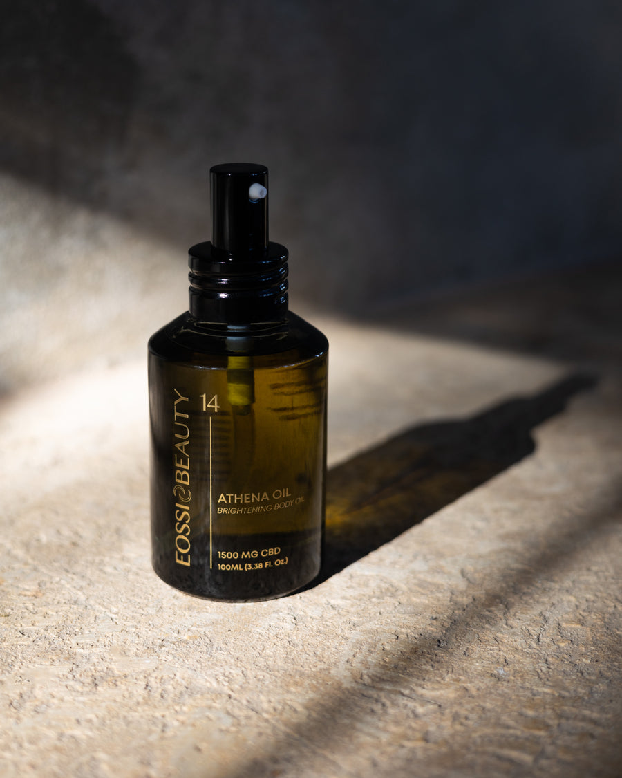 Eossi Beauty Athena Brightening Body Oil 100ml spray bottle in sunlight and shadow