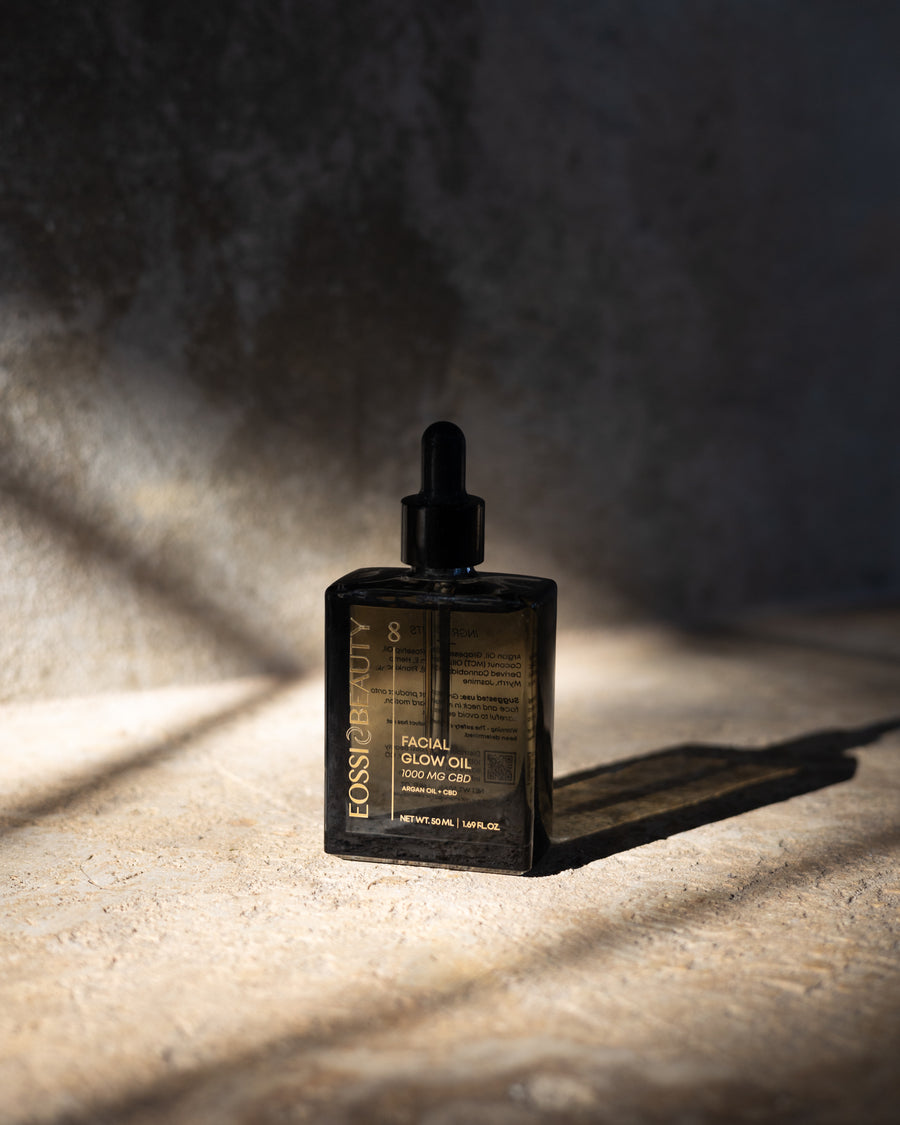 Eossi Beauty #8 Facial Glow Oil 50ml glass dropper bottle in dramatic sunlight and shadow